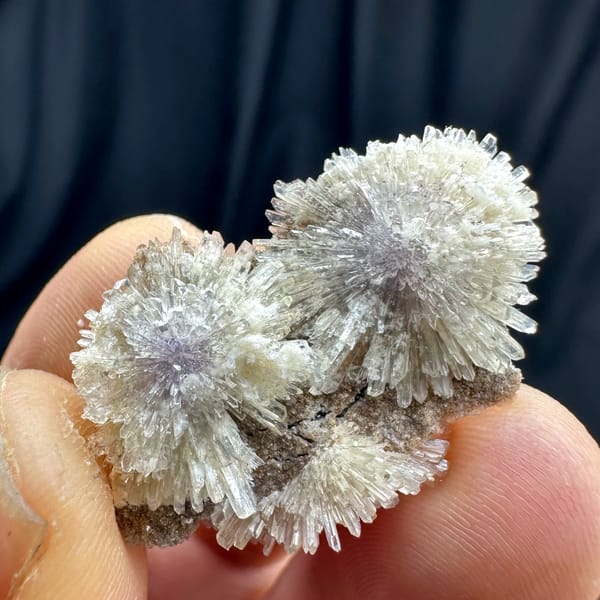 Purple-cored creedite needle sprays on matrix from Guizhou, China, close-up of the crystal faces