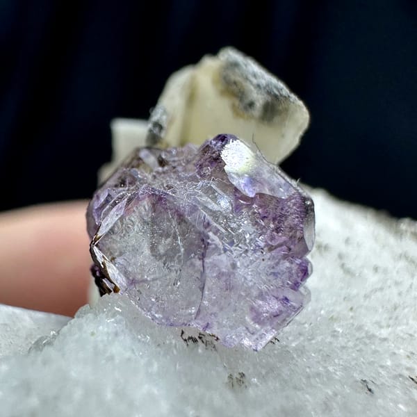 Small purple fluorite cube on pale feldspar floater from Yunxiao, Fujian, China, close-up of the crystal faces