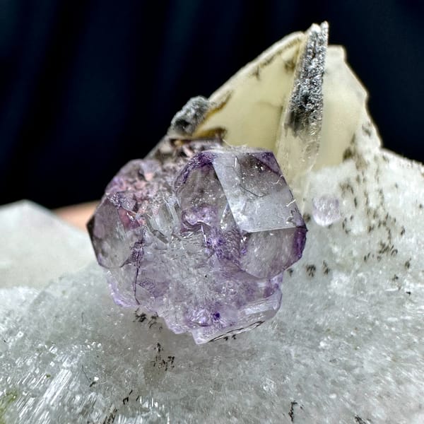 Small purple fluorite cube on pale feldspar floater from Yunxiao, Fujian, China, top view