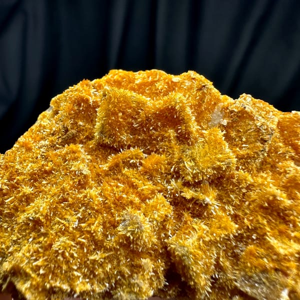 Fluorite cubes coated in orange jarosite crust from Guizhou, China, close-up of the crystal faces