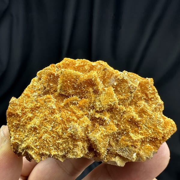 Fluorite cubes coated in orange jarosite crust from Guizhou, China, detail of the matrix contact