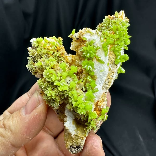 Lime-green pyromorphite crystal rosettes on grey matrix from Guangxi, China, close-up of the crystal faces