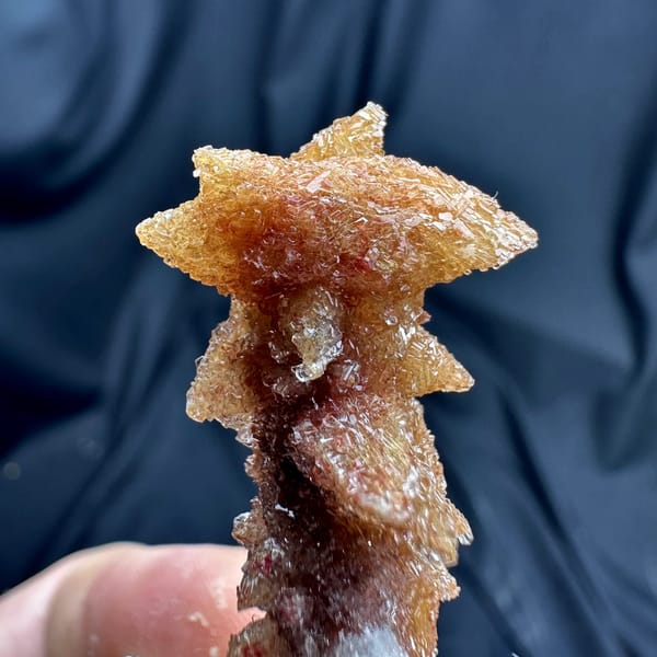 Rust-red double-terminated calcite crystal enclosed in white gypsum from Guizhou, China, second angle