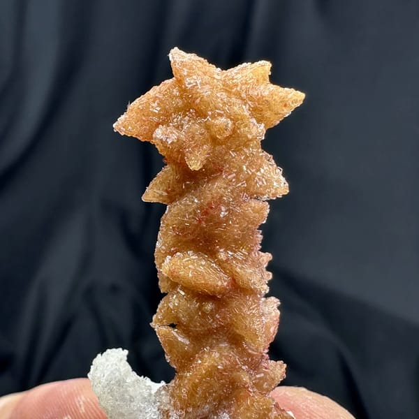 Rust-red double-terminated calcite crystal enclosed in white gypsum from Guizhou, China, reverse side