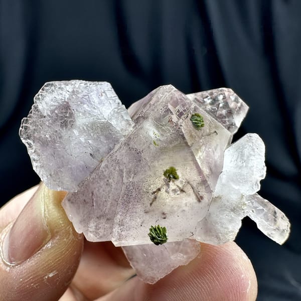 Lilac quartz floater with green epidote inclusions from Sichuan, China, detail of the matrix contact