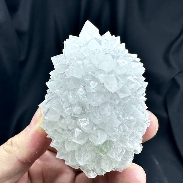 Dome of pale quartz points with green fluorite from Guangdong, China, close-up of the crystal faces