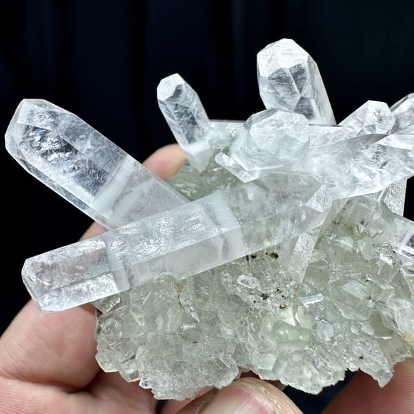 Crossed double-terminated calcite prisms with green fluorite and pyrite from Fujian, China, close-up of the crystal faces
