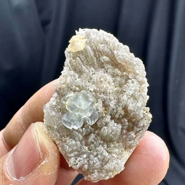 Pale blue-green stepped fluorite cube on feldspar matrix from Yunxiao, Fujian, China, reverse side