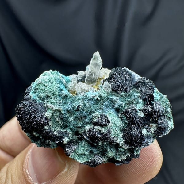 Green malachite with black specular hematite rosettes and quartz from Inner Mongolia, China, detail of the matrix contact
