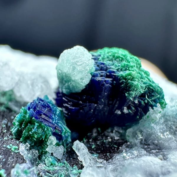 Malachite rosette with azurite on white calcite from Morocco, close-up of the crystal faces