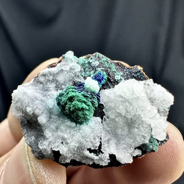 Malachite rosette with azurite on white calcite from Morocco, detail of the matrix contact