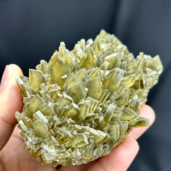 Cluster of straw-yellow bladed baryte crystals from Yunnan, China, close-up of the crystal faces