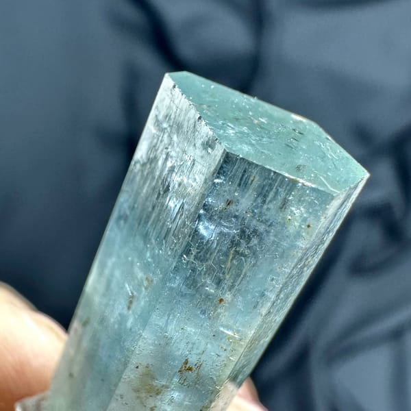 Pale blue double-terminated aquamarine crystal with dolomite from Namibia, close-up of the crystal faces