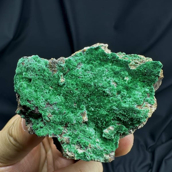 Velvet green moss malachite covering a rounded matrix from Yunnan, China, detail of the matrix contact
