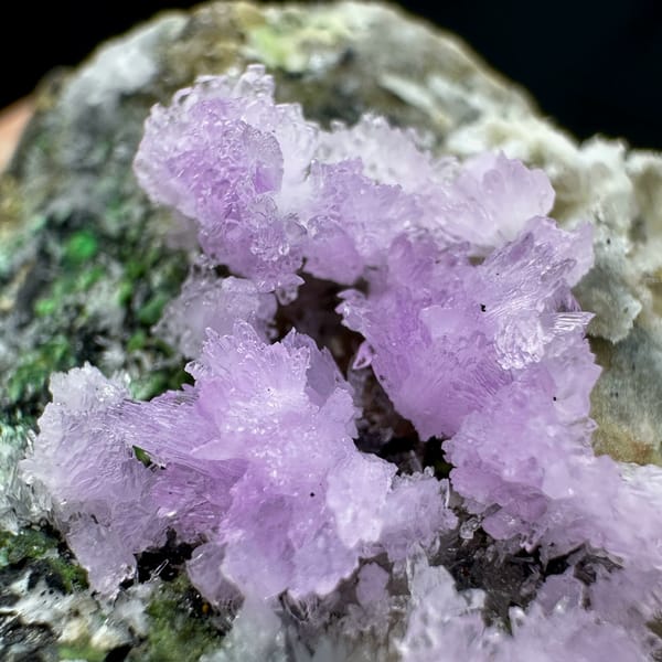 Pink aragonite sprays with green malachite on grey matrix from Yunnan, China, close-up of the crystal faces