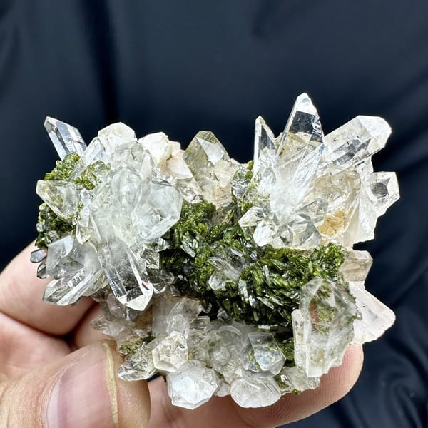 Transparent quartz cluster with green epidote from Sichuan, China, detail of the matrix contact