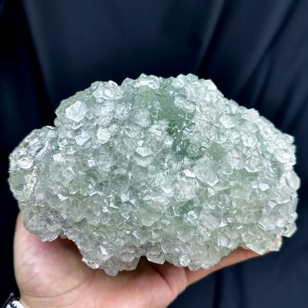 Large pale green sugar-textured fluorite floater with calcite from Fujian, China, close-up of the crystal faces
