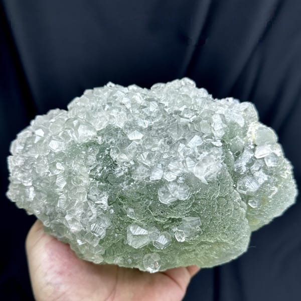 Large pale green sugar-textured fluorite floater with calcite from Fujian, China, detail of the matrix contact