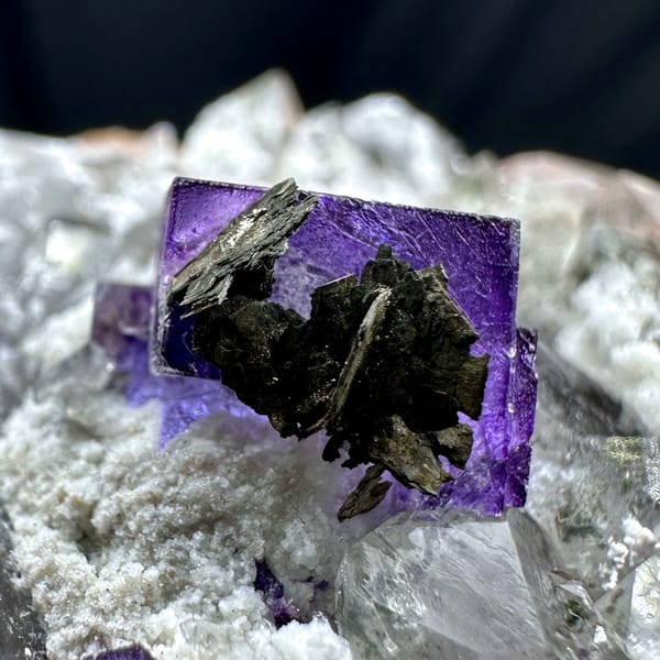 Deep purple fluorite cube on quartz with pyrrhotite from Yaogangxian Mine, Hunan, China, close-up of the crystal faces