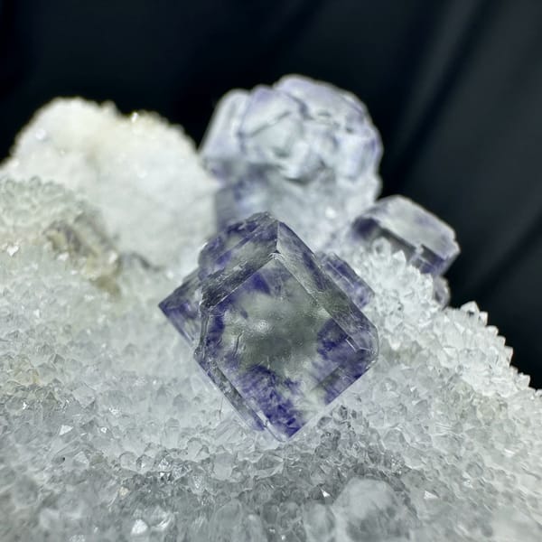 Glassy blue-green fluorite cubes on white quartz druse from Fujian, China, second angle