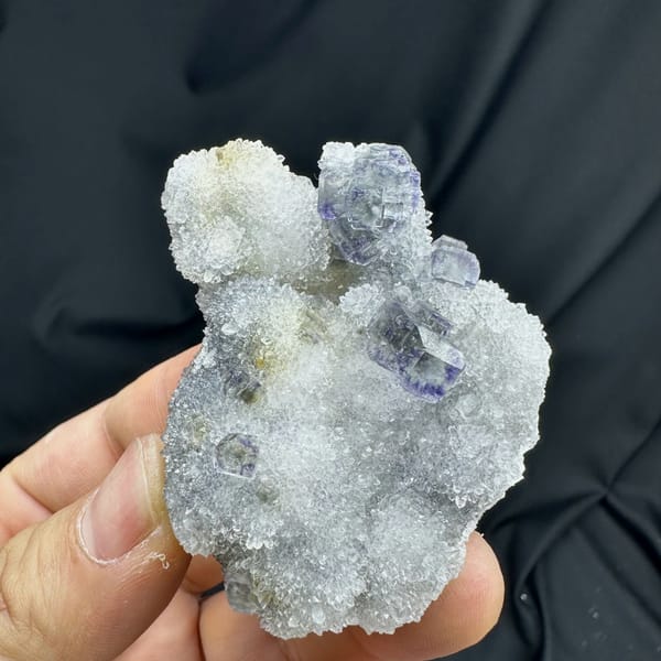 Glassy blue-green fluorite cubes on white quartz druse from Fujian, China, reverse side