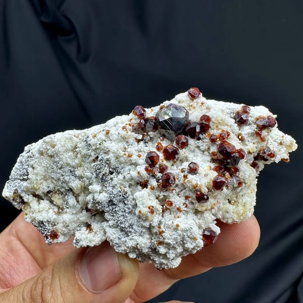 Wine-red garnet crystals with hyalite opal on feldspar from Yunxiao, Fujian, China, reverse side
