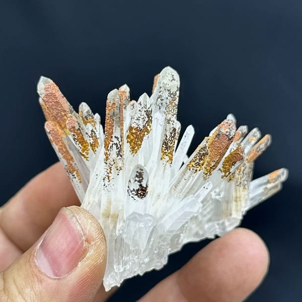 Fan of clear quartz prisms with orange-stained tips from Guangdong, China, second angle