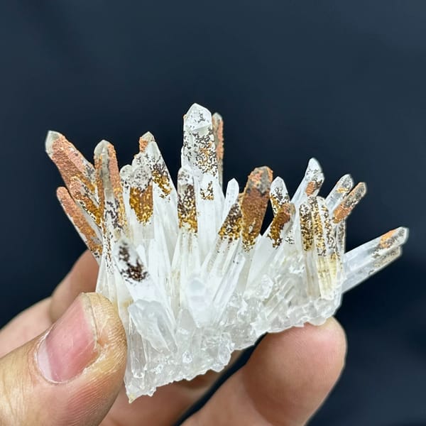 Fan of clear quartz prisms with orange-stained tips from Guangdong, China, reverse side