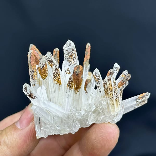 Fan of clear quartz prisms with orange-stained tips from Guangdong, China, top view