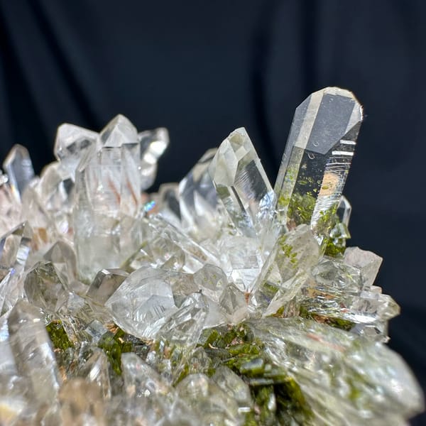 Clear quartz point cluster over green epidote from Sichuan, China, second angle