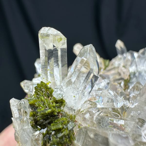 Clear quartz point cluster over green epidote from Sichuan, China, close-up of the crystal faces