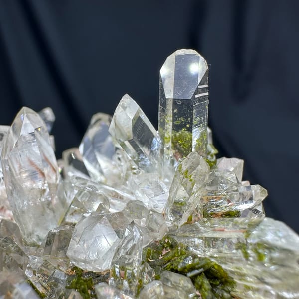 Clear quartz point cluster over green epidote from Sichuan, China, top view