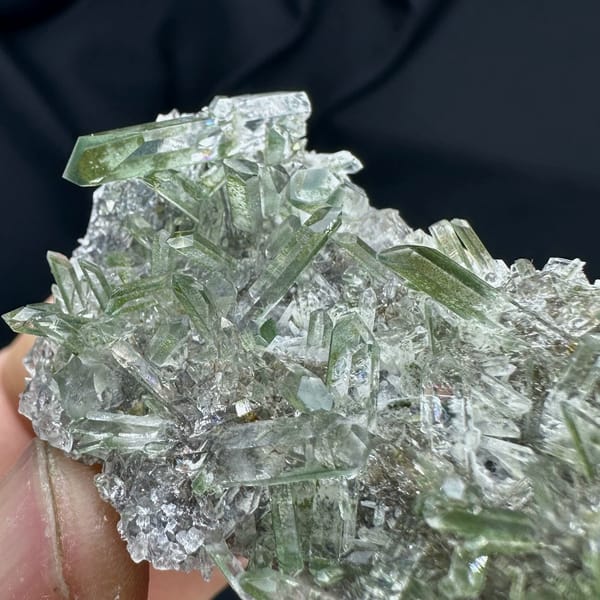 Green phantom quartz needle cluster from Sichuan, China, close-up of the crystal faces