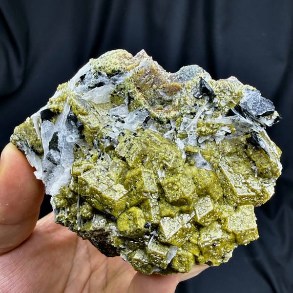 Olive-green grossular garnet crystals with white calcite blades from Inner Mongolia, China, second angle