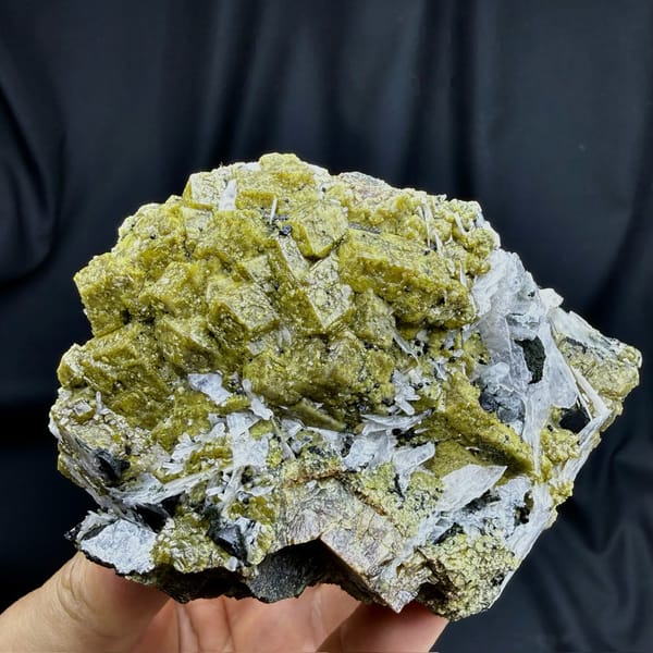 Olive-green grossular garnet crystals with white calcite blades from Inner Mongolia, China, detail of the matrix contact