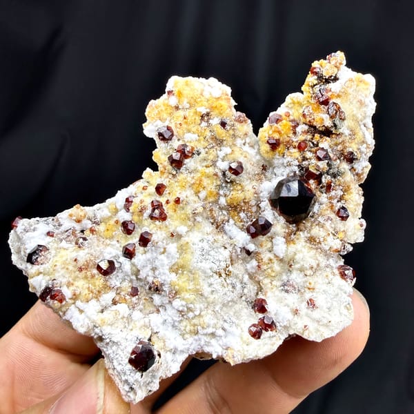 Large dark-red garnet crystals with hyalite opal on feldspar from Yunxiao, Fujian, China, reverse side