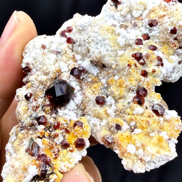 Large dark-red garnet crystals with hyalite opal on feldspar from Yunxiao, Fujian, China, top view