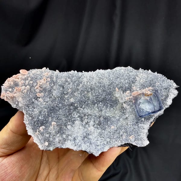 Blue-rimmed fluorite cube on grey quartz with pink rhodochrosite from Wuzhou, Guangxi, China, top view