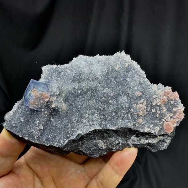 Blue-rimmed fluorite cube on grey quartz with pink rhodochrosite from Wuzhou, Guangxi, China, detail of the matrix contact