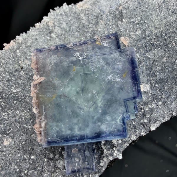 Blue-and-white porcelain fluorite cubes on quartz with rhodochrosite from Wuzhou, Guangxi, close-up of the crystal faces