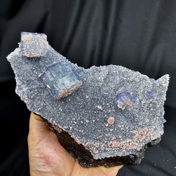Blue-and-white porcelain fluorite cubes on quartz with rhodochrosite from Wuzhou, Guangxi, detail of the matrix contact
