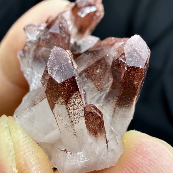 Clear quartz cluster with red hematite phantoms from Shanxi, China, second angle