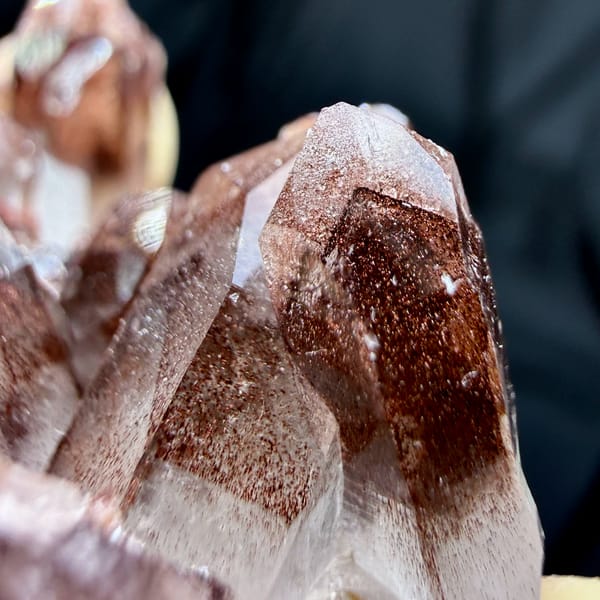 Clear quartz cluster with red hematite phantoms from Shanxi, China, close-up of the crystal faces
