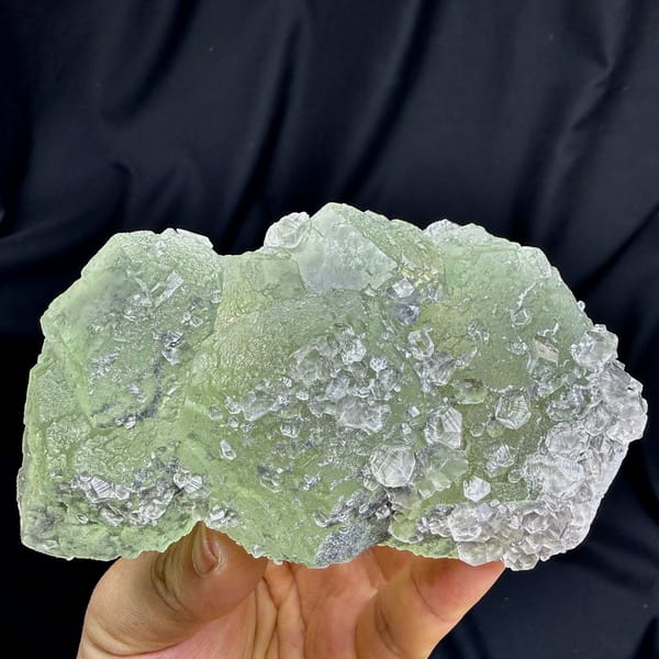 Pale green fluorite floater with clear calcite crystals from Fujian, China, close-up of the crystal faces