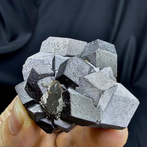 Cluster of large steel-grey magnetite crystals from Inner Mongolia, China, close-up of the crystal faces