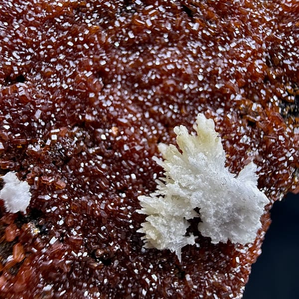 Slab covered in fine red vanadinite druse with aragonite from Morocco, second angle