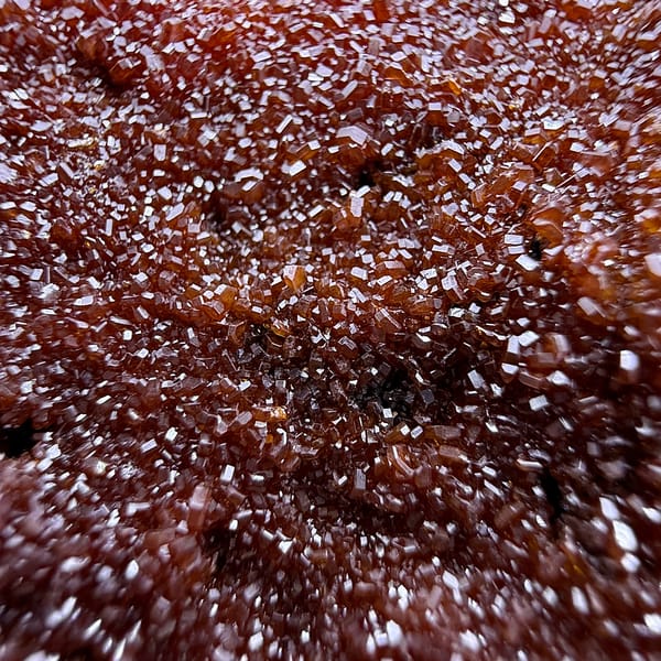 Slab covered in fine red vanadinite druse with aragonite from Morocco, top view