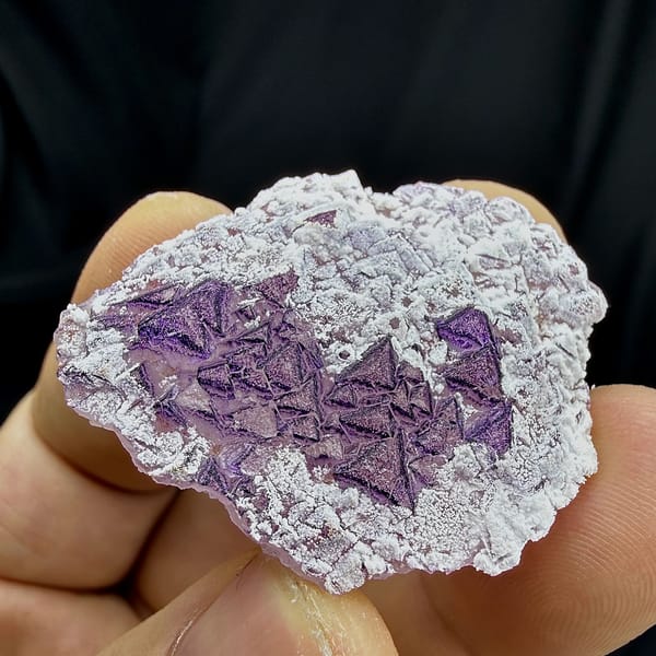 Deep purple triangular fluorite crystals in white aragonite from Yunnan, China, top view