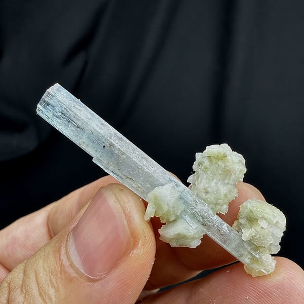Sky-blue aquamarine prism standing on white feldspar from Namibia, reverse side