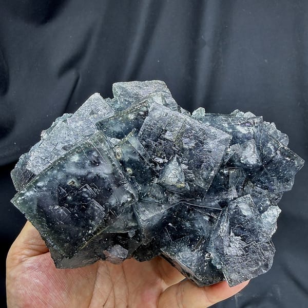 Large blue-grey daylight fluorite cubes with pyrite from Nigeria, detail of the matrix contact